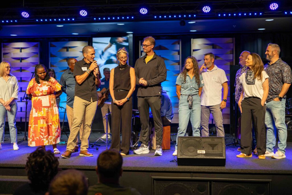 Growth Resourcing Group welcoming and praying for new partners at the 2026 global gathering.
